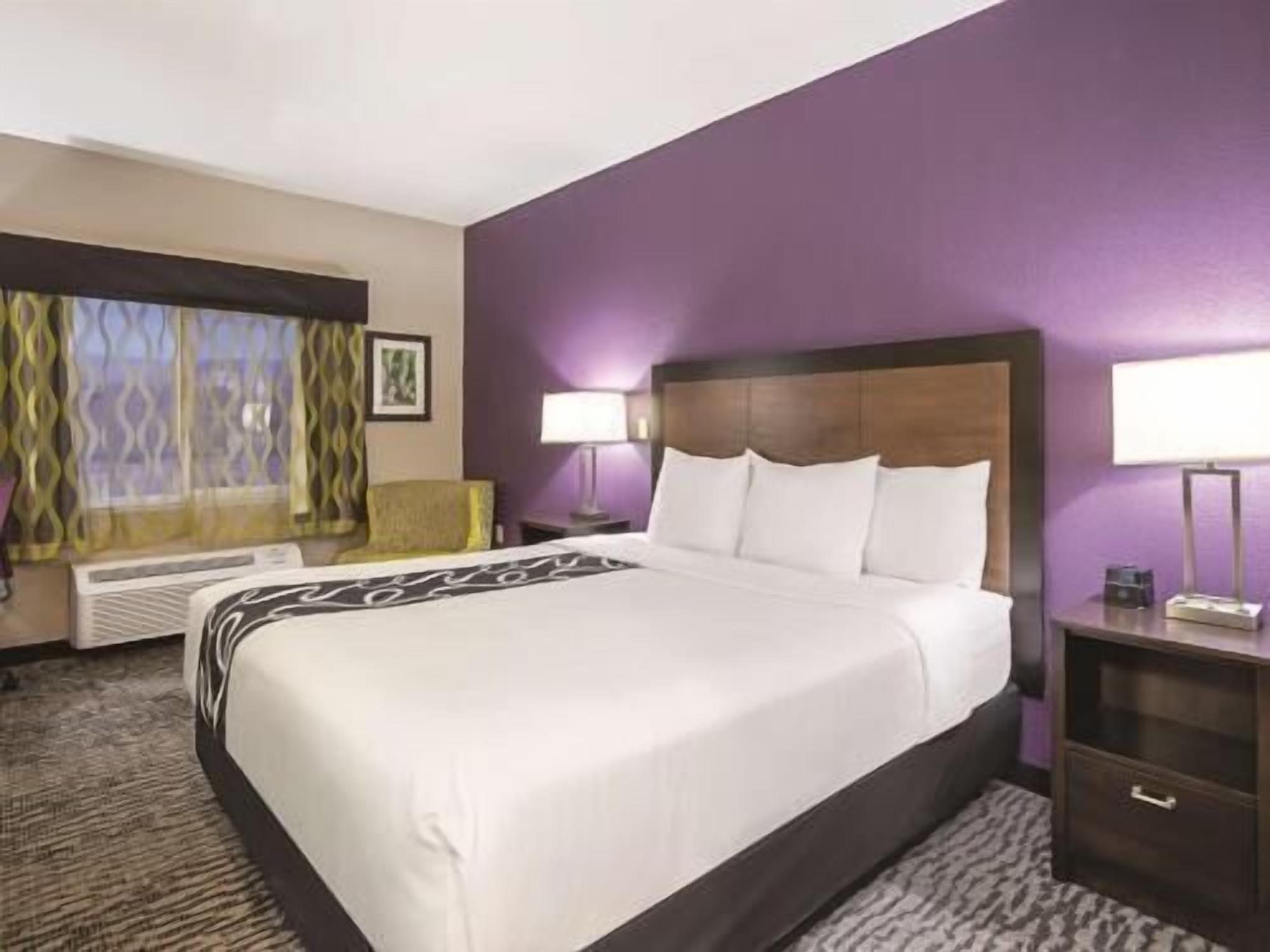Premium bedding, desk, laptop workspace, blackout drapes