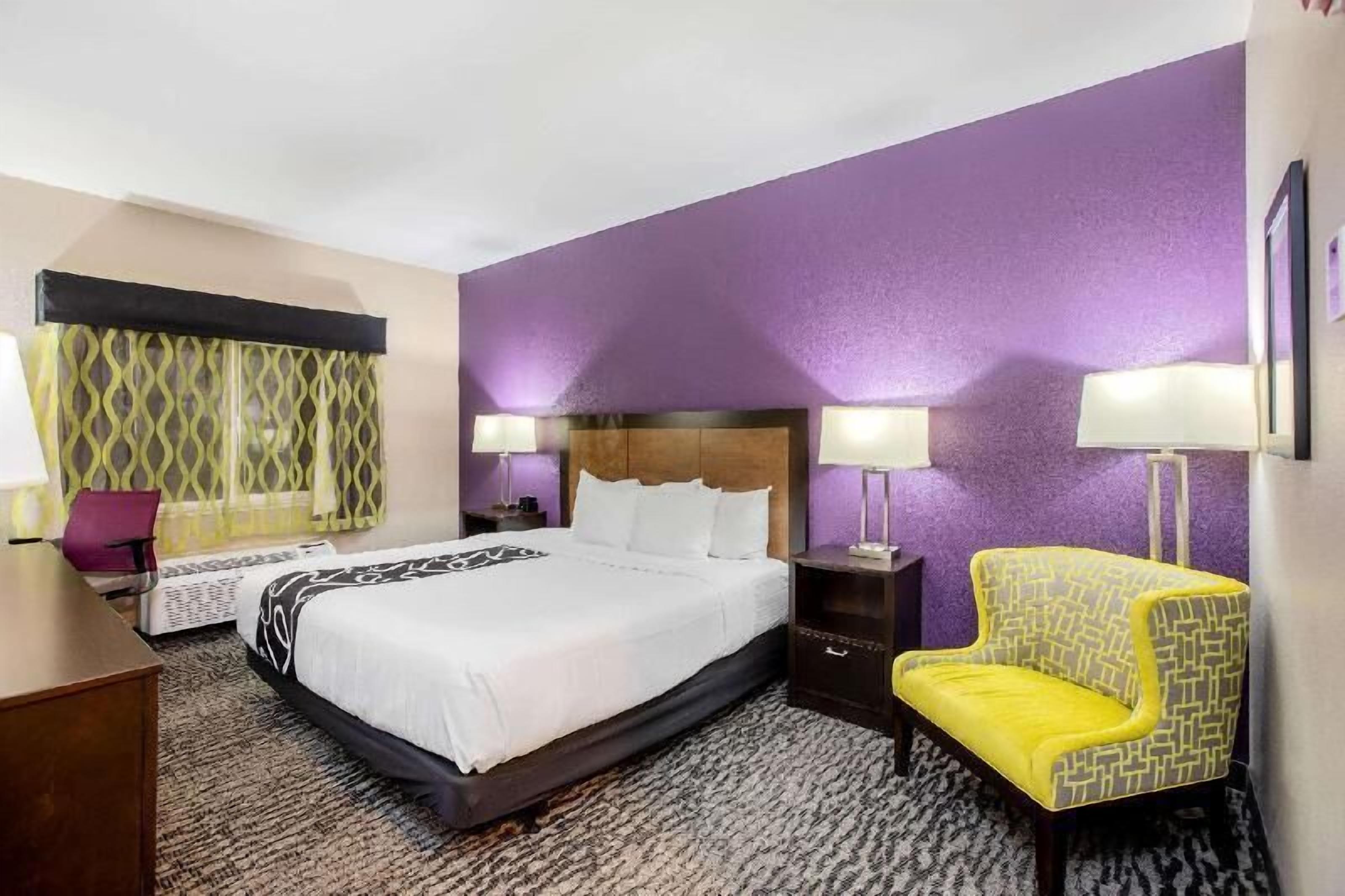 Premium bedding, desk, laptop workspace, blackout drapes