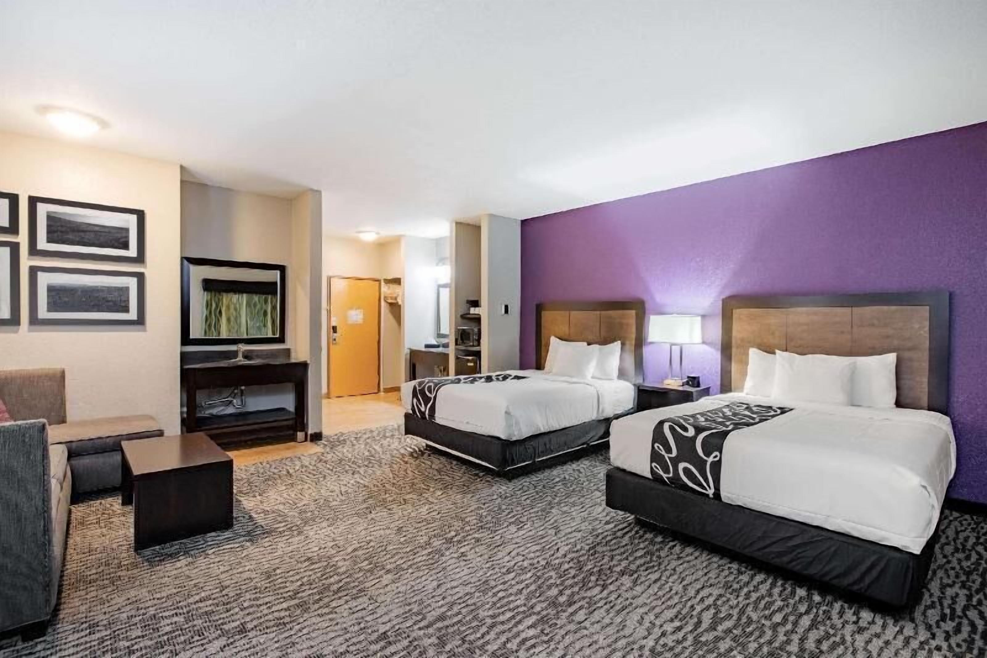 Premium bedding, desk, laptop workspace, blackout drapes