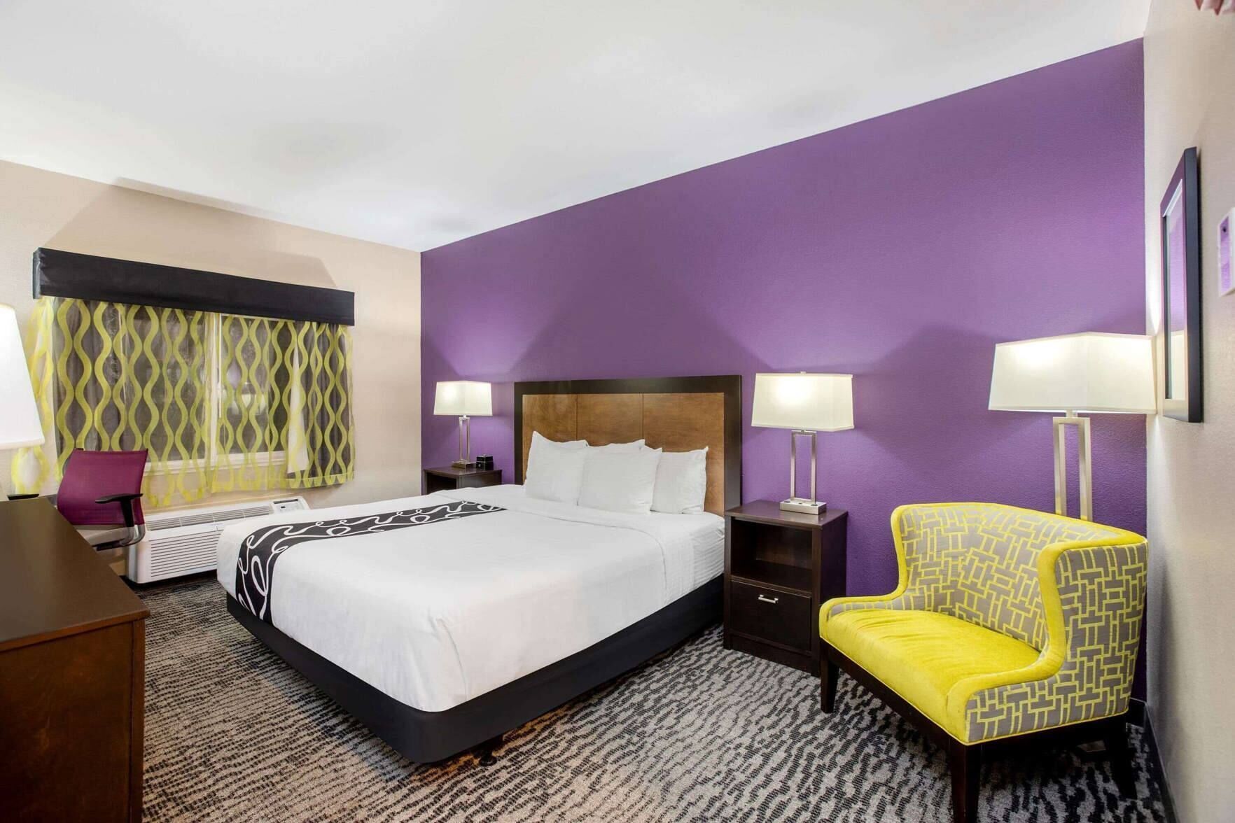 Premium bedding, desk, laptop workspace, blackout drapes