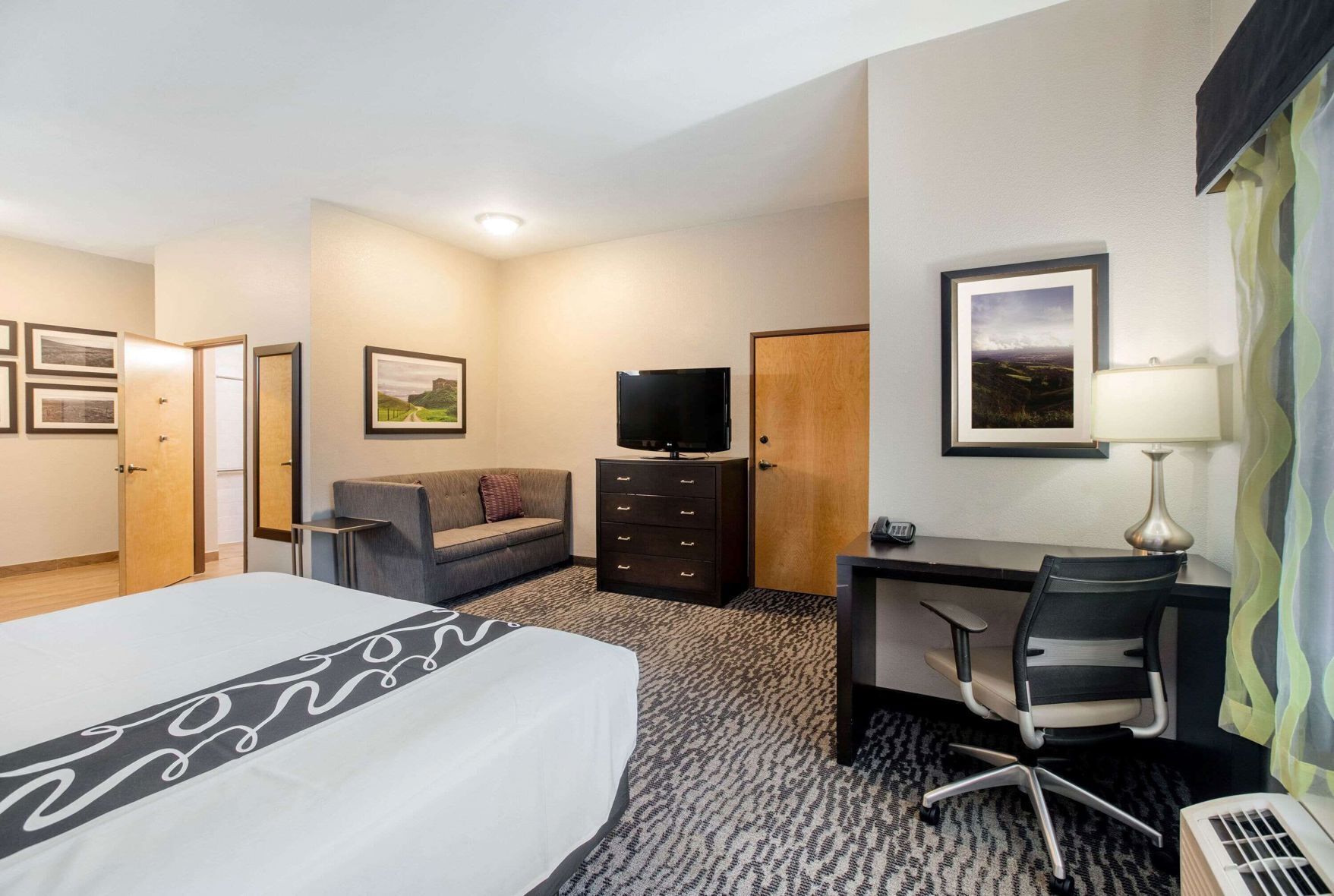 Premium bedding, desk, laptop workspace, blackout drapes