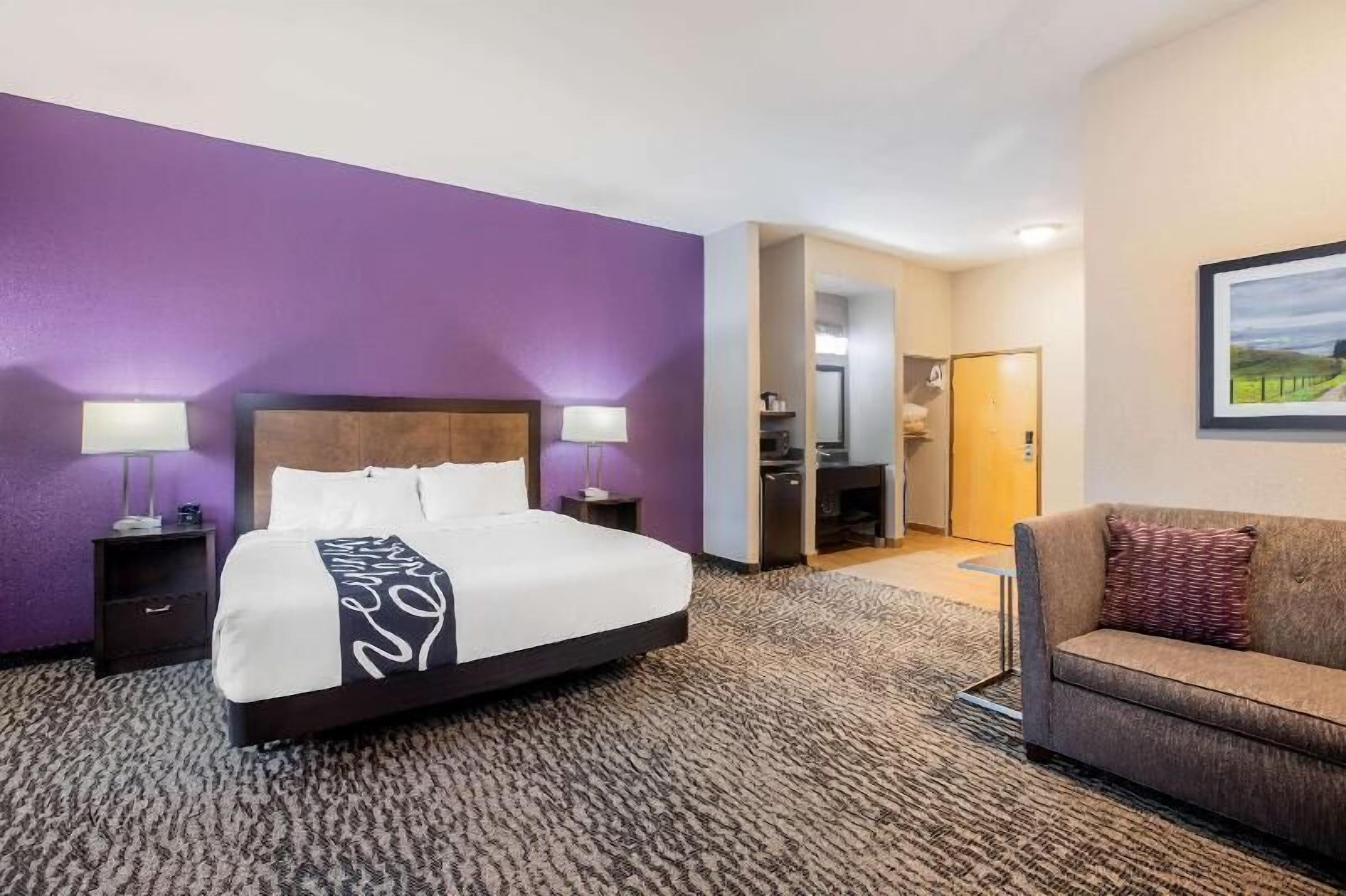 Premium bedding, desk, laptop workspace, blackout drapes