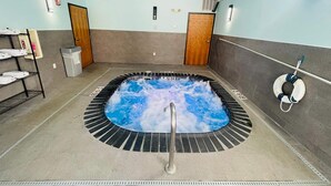 A spa area with a hot tub, towels, and a lifebuoy. - Wingate by Wyndham Vienna/Parkersburg/Marietta (Vienna)