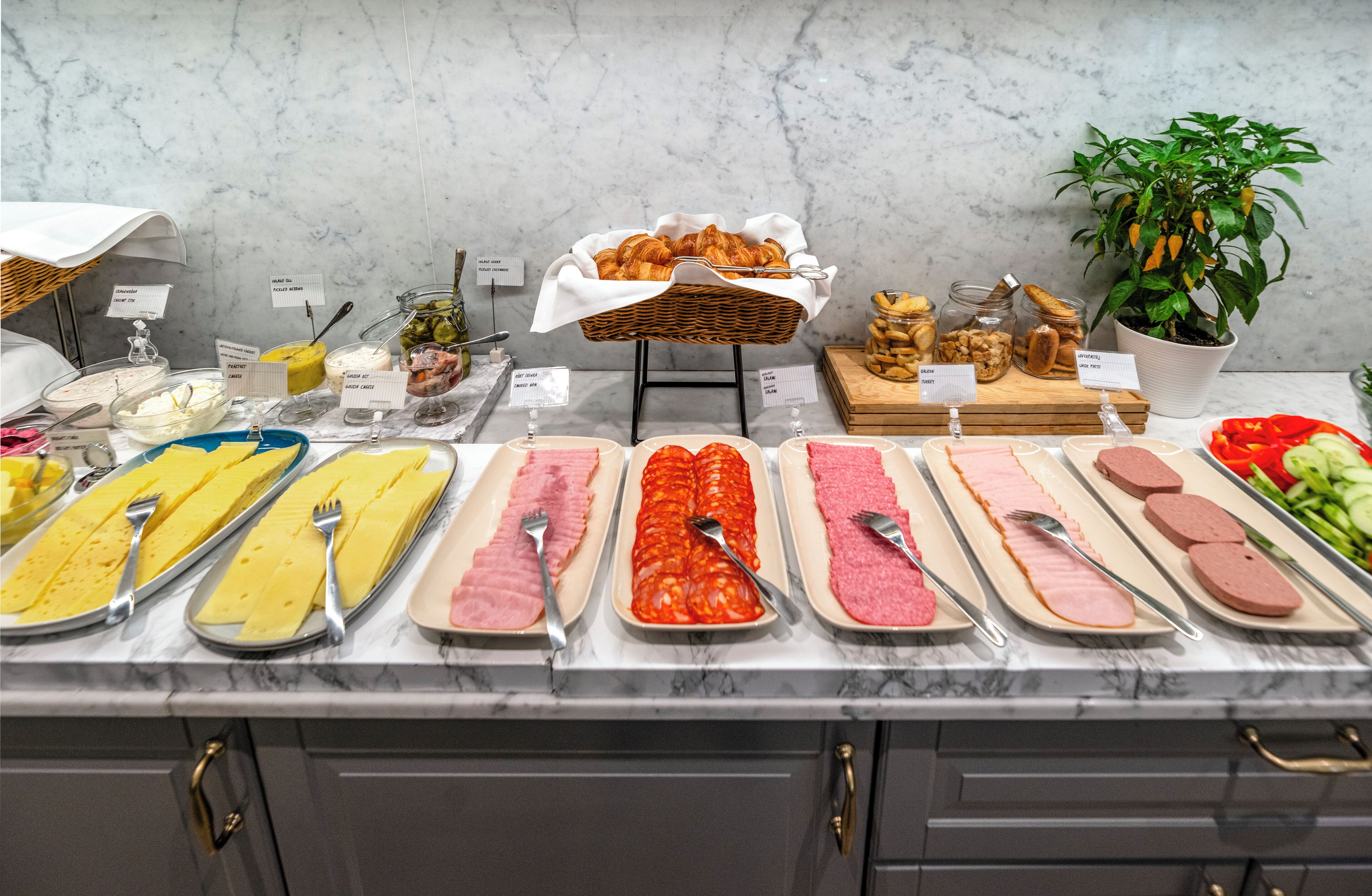 A buffet with various food items and utensils.