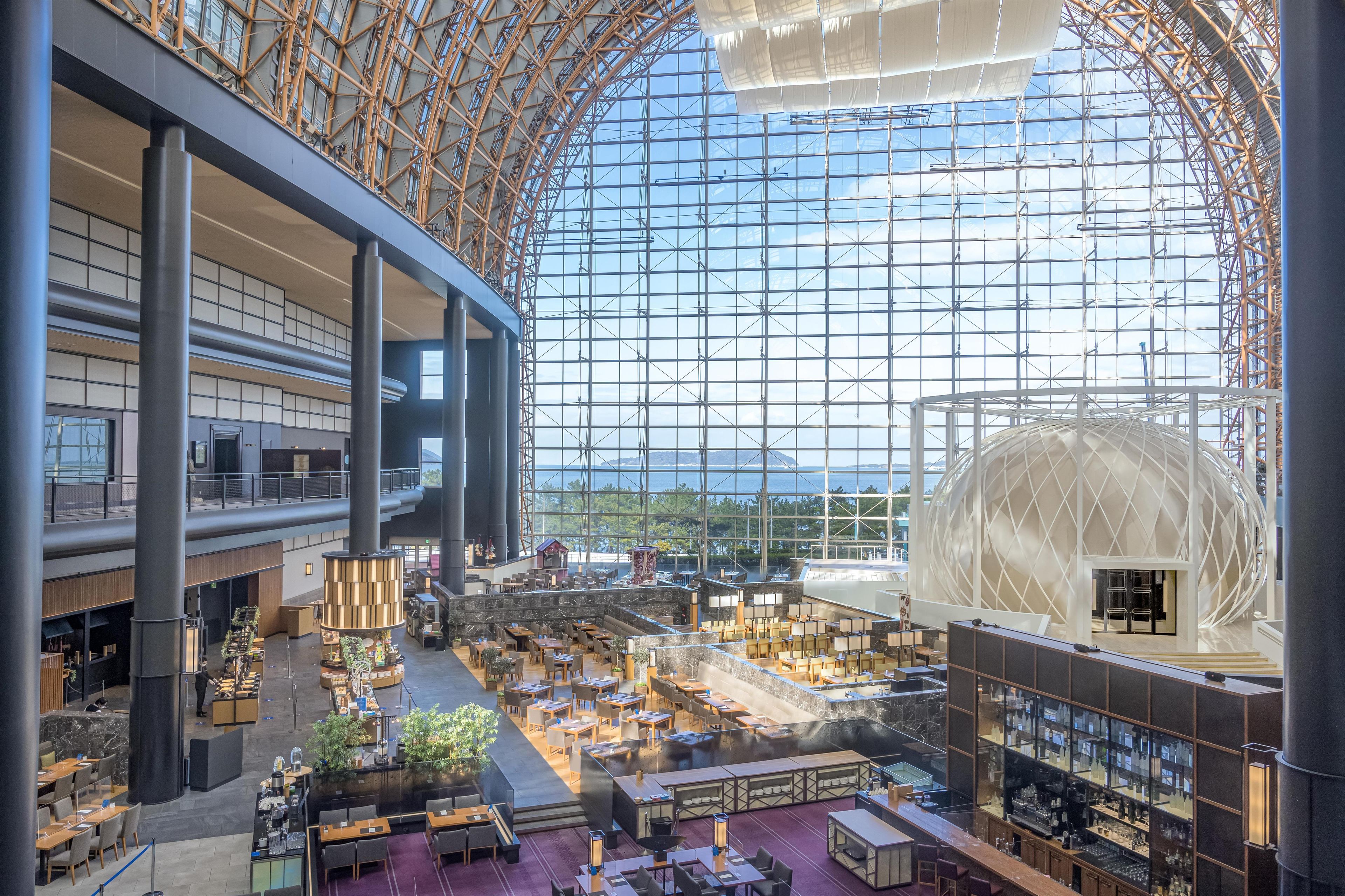 A spacious indoor area with multiple levels, large windows, and a distinctive dome structure.