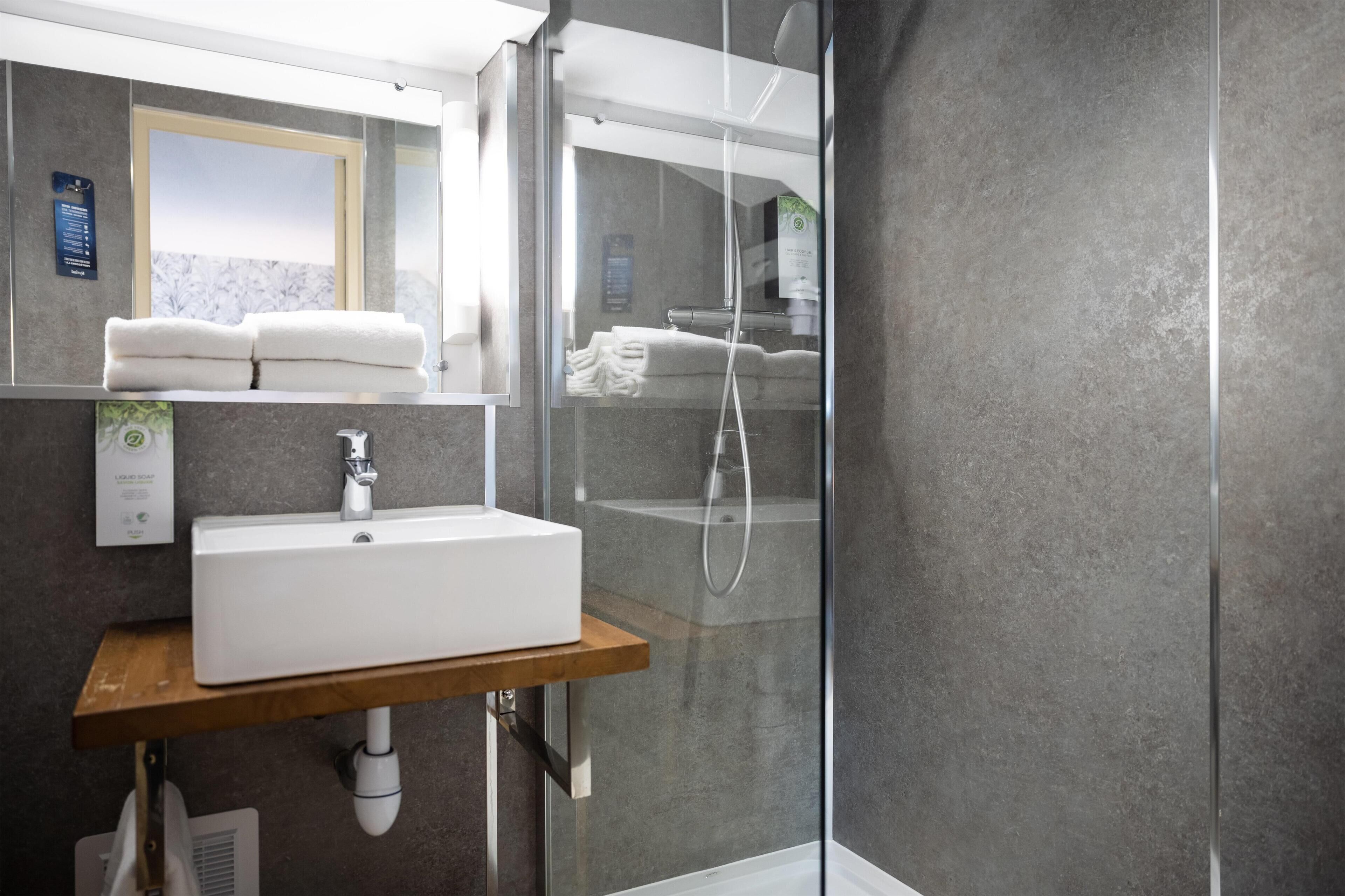 Combined shower/tub, eco-friendly toiletries, hair dryer, slippers