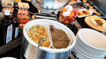 A buffet with various dishes, including rice, meat, and vegetables.