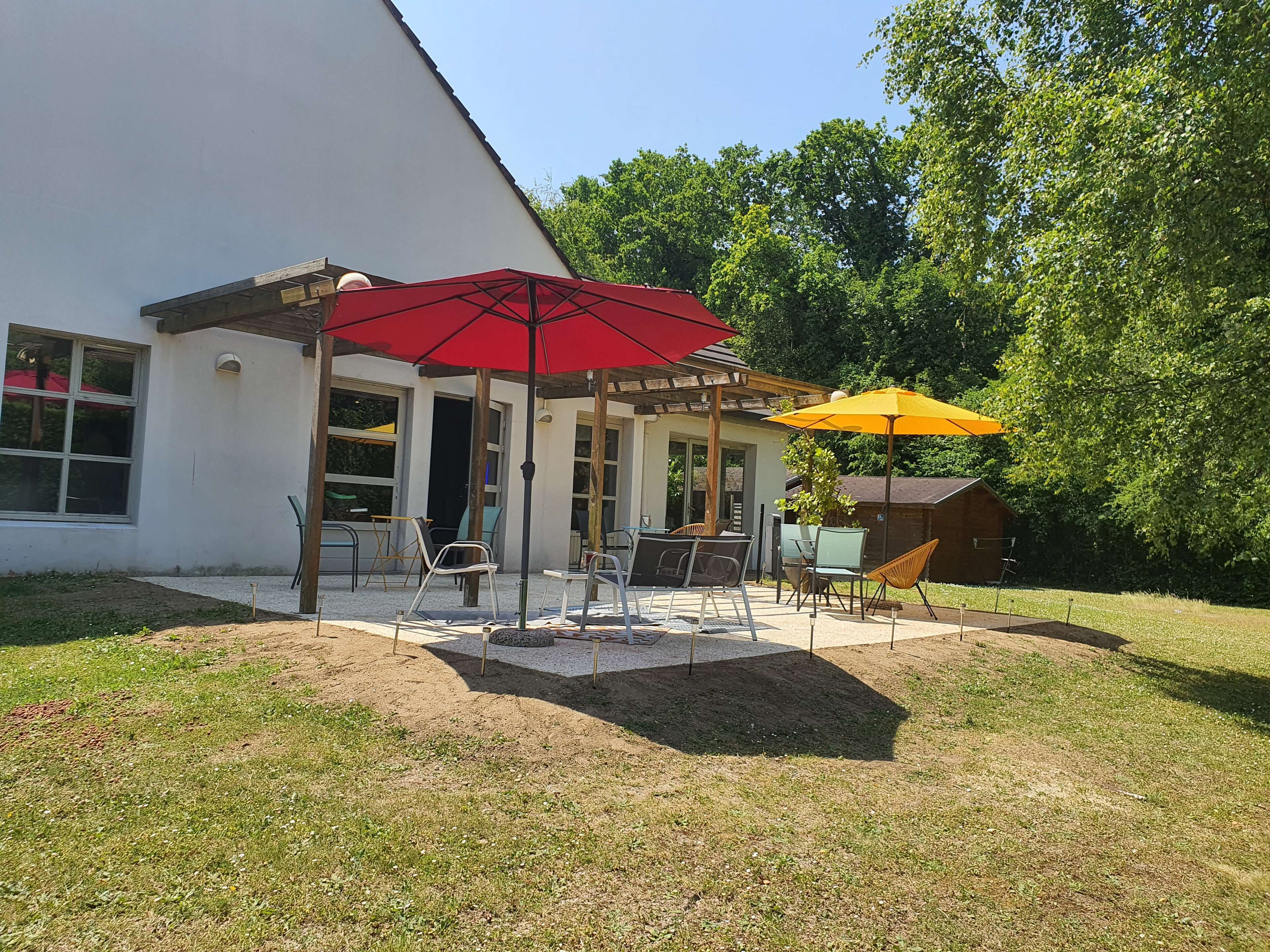 A patio area with outdoor seating and umbrellas.