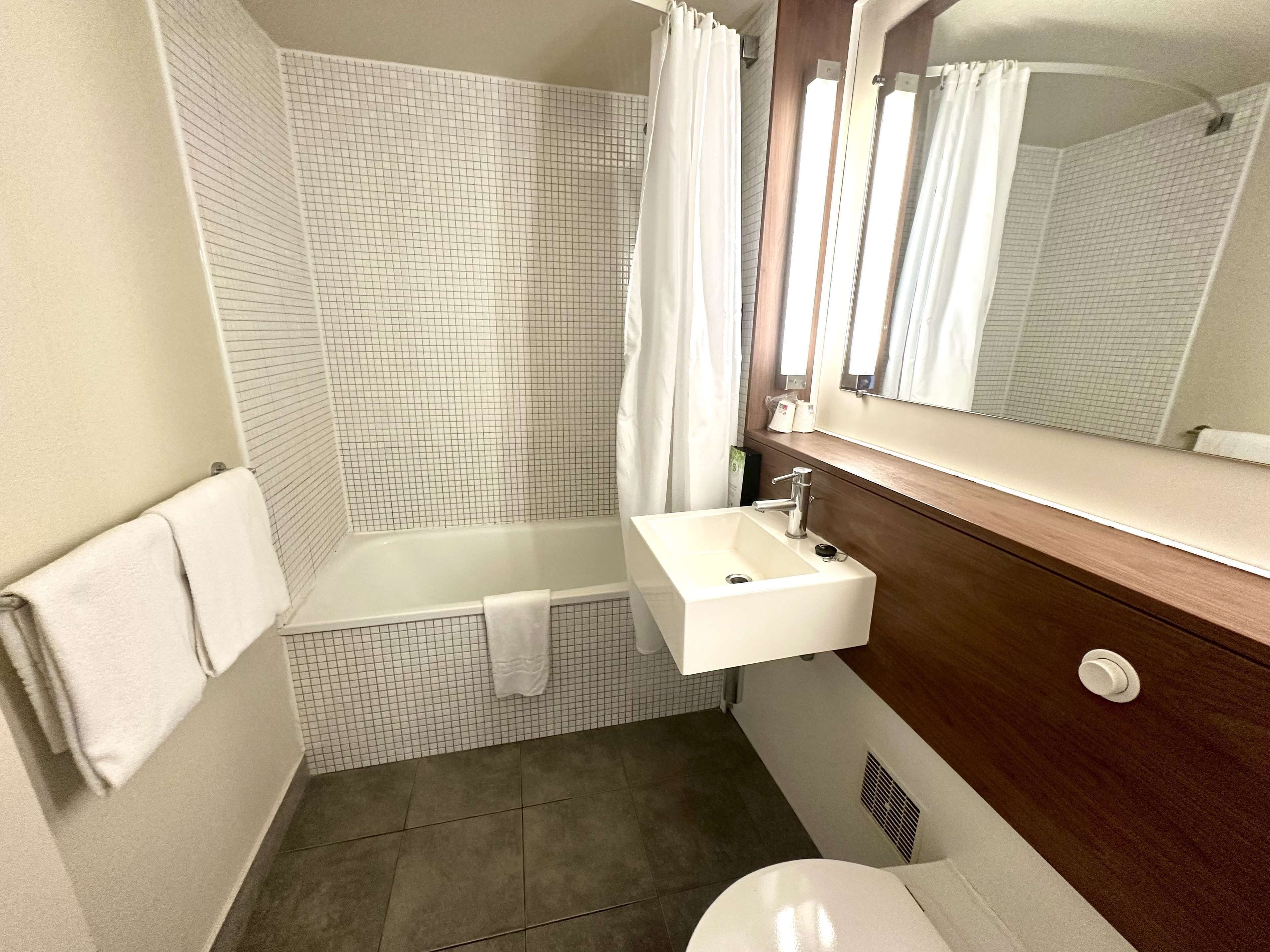 A bathroom with a bathtub, a sink, and a toilet.