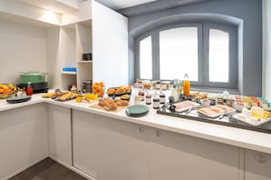 A breakfast buffet with various food items and condiments. - Best Western Dijon Centre Gare (Dijon)