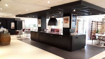 A modern reception area with a central counter, seating area, and a large window providing natural light.