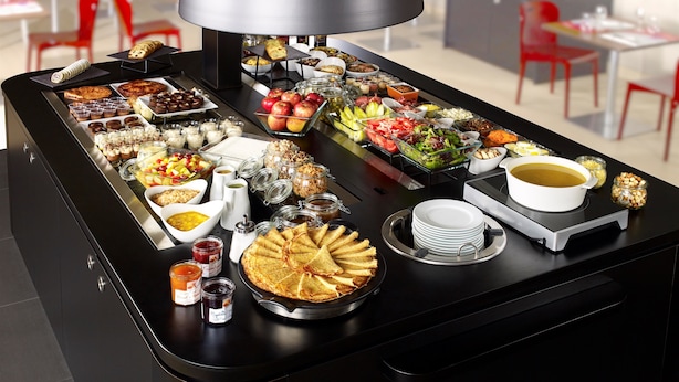 A buffet with various food items and condiments.