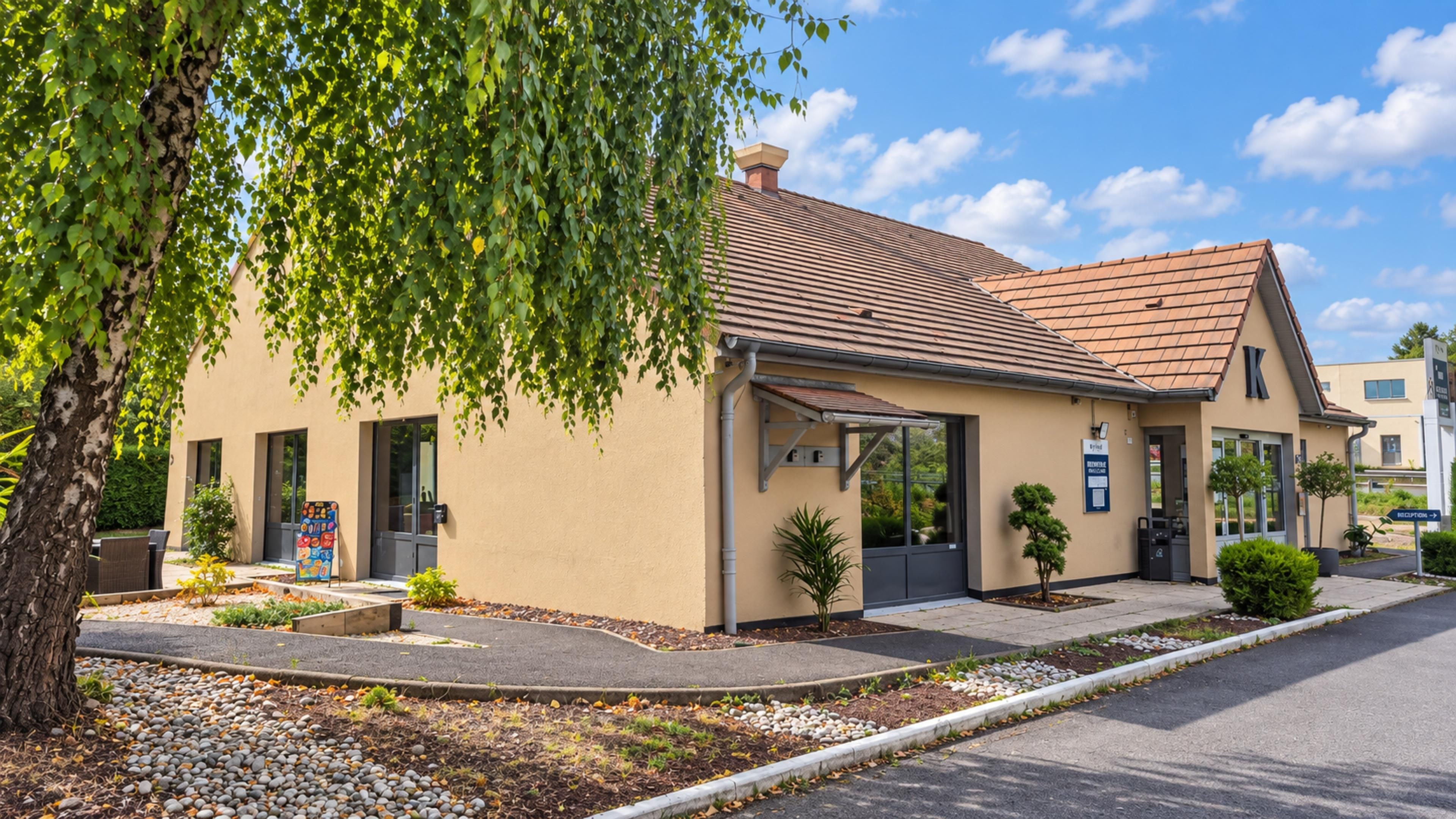 A two-story building with a tiled roof, a covered entrance, and a sign indicating a reception area.