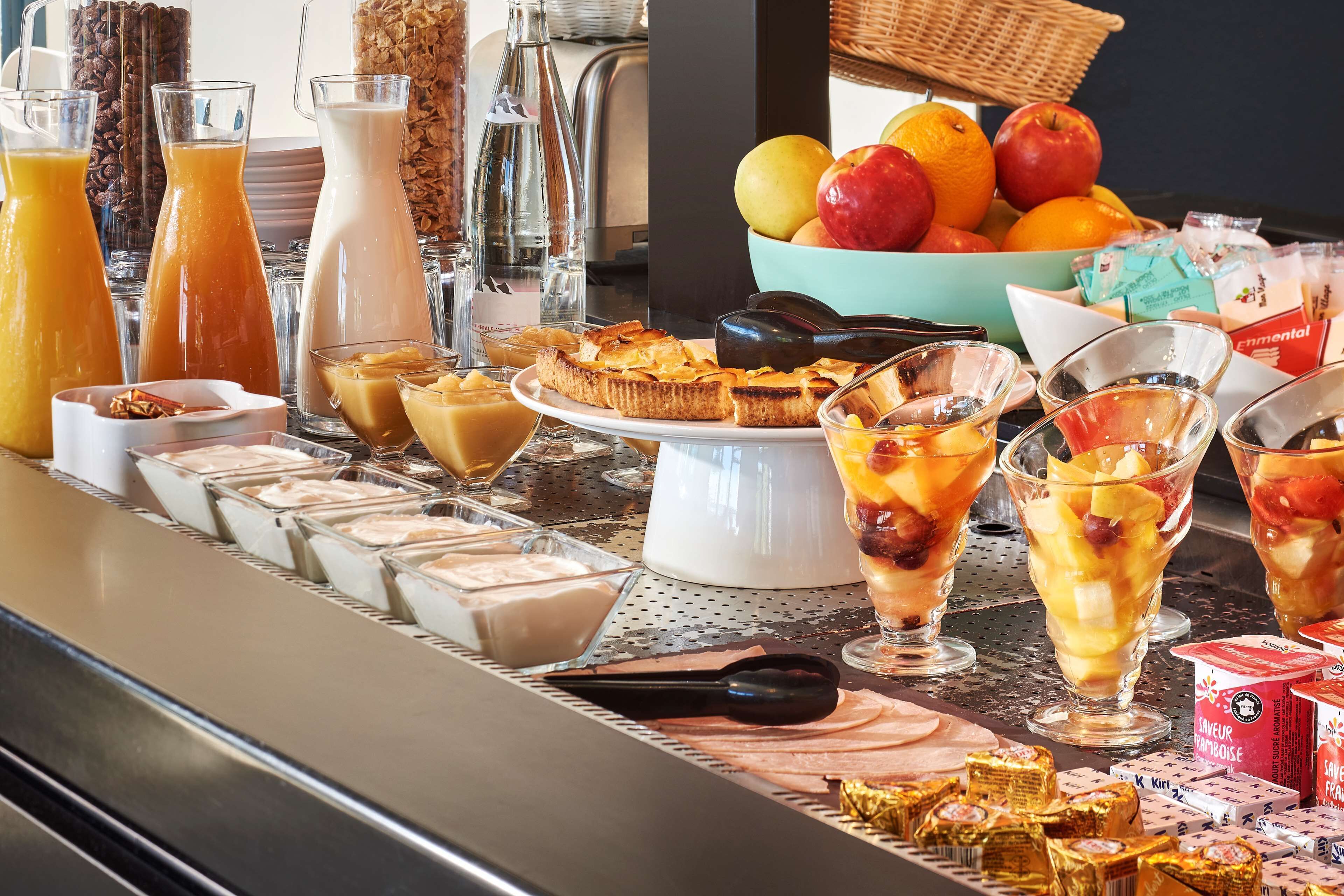 A breakfast buffet with various food items and beverages.