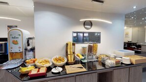 A breakfast buffet with Tropicana juice, bread, pastries, and various spreads. - Kyriad Fontenay Tresigny (Fontenay-Tresigny)