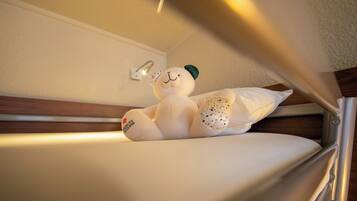 A bed with a plush toy on it.