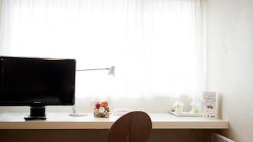 Premium bedding, desk, laptop workspace, blackout curtains