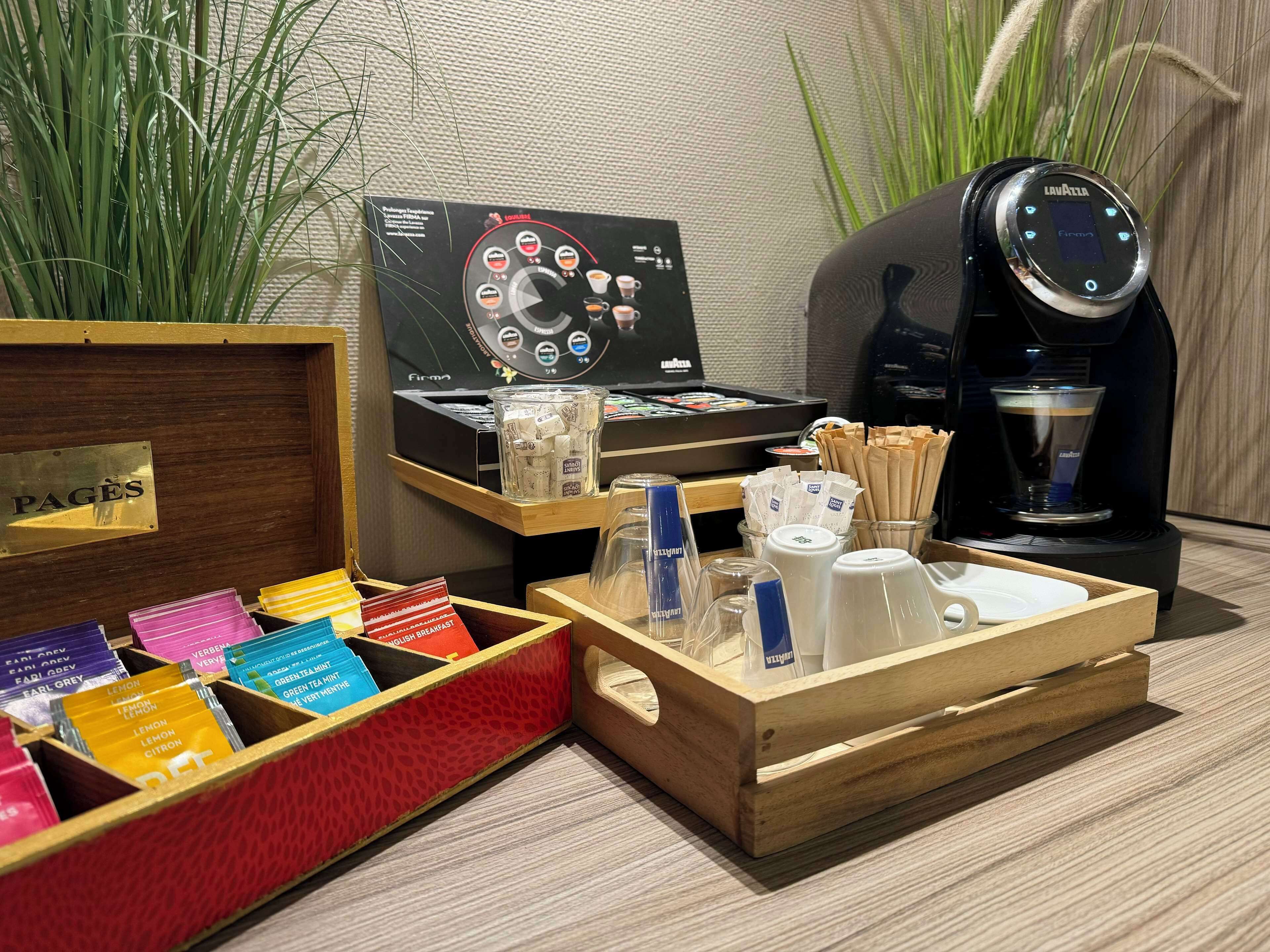 A coffee station with a coffee machine, a coffee grinder, and a selection of coffee pods.