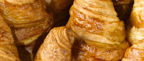 A close-up of golden-brown pastries with a flaky texture.