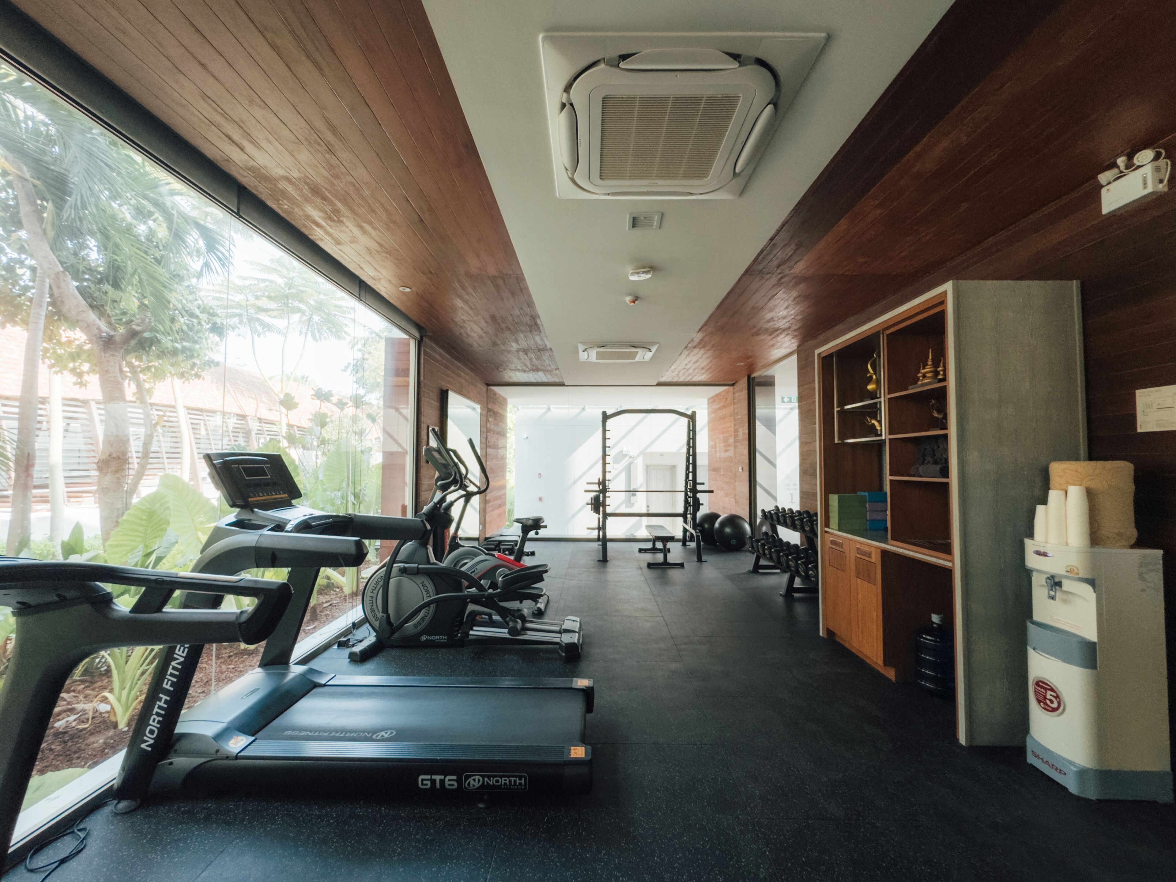 A gym with treadmills, weights, and exercise equipment.