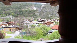 A view of a village with houses, a church, and a mountain backdrop. - Hotel Tyrolis (Zirl)