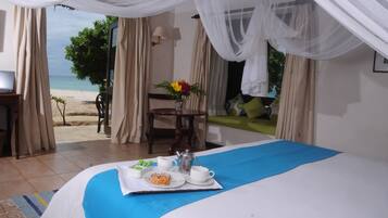 Beach Front Room | Minibar, in-room safe, desk, blackout drapes