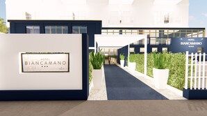 A modern hotel entrance with a sign reading "HOTEL BIANCAMANO". - Hotel Biancamano (Rimini)