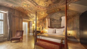 A luxurious bedroom with a four-poster bed, a chaise lounge, and a large mural on the ceiling. - The Mozart Prague by Accor (Prague)
