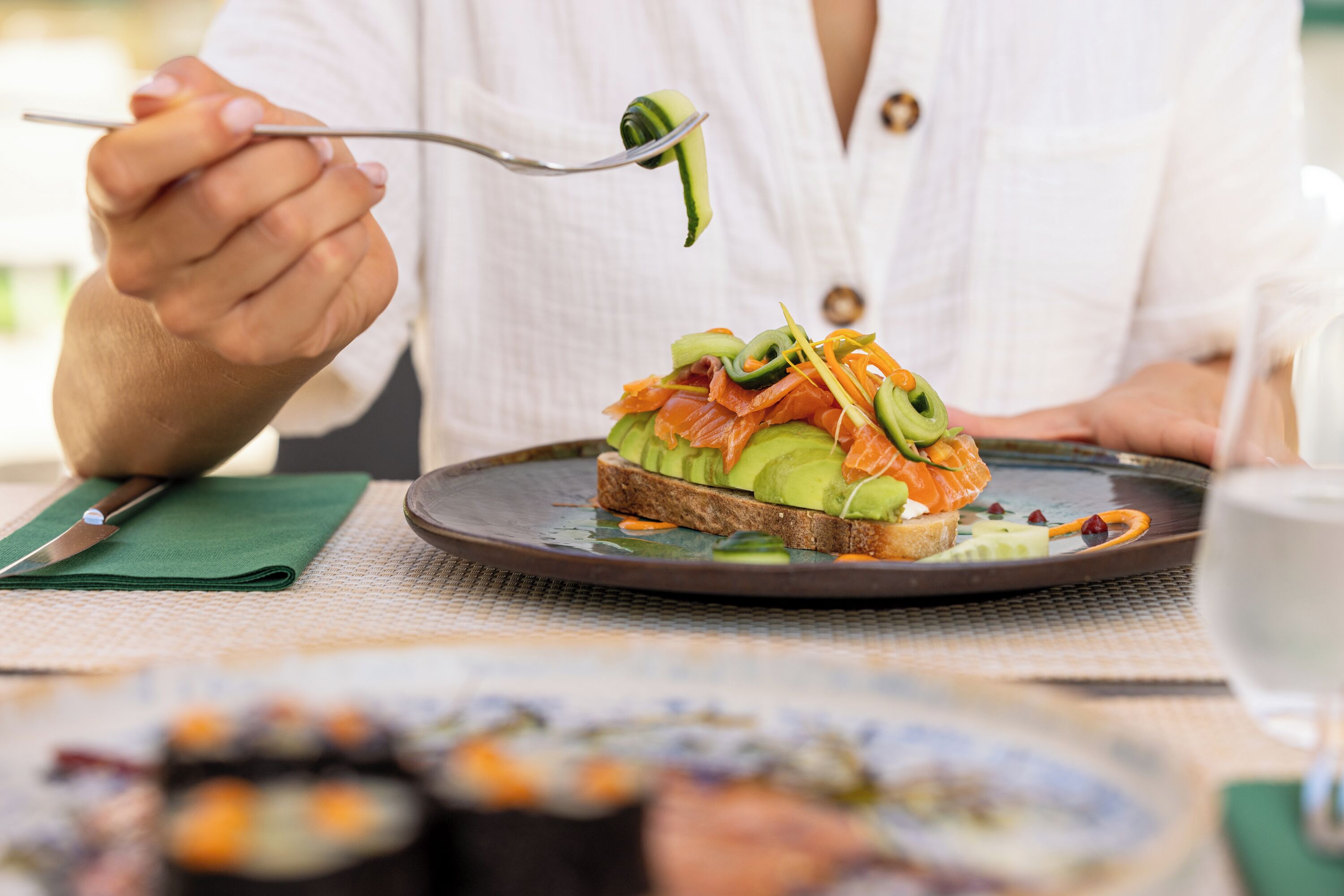 A person holding a fork with a piece of food on it.