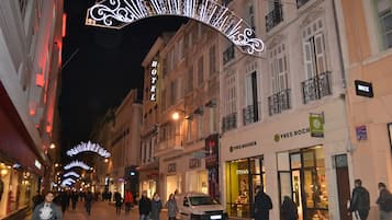 A hotel with a sign reading "HOTEL" and "YVES ROCH" on the facade.