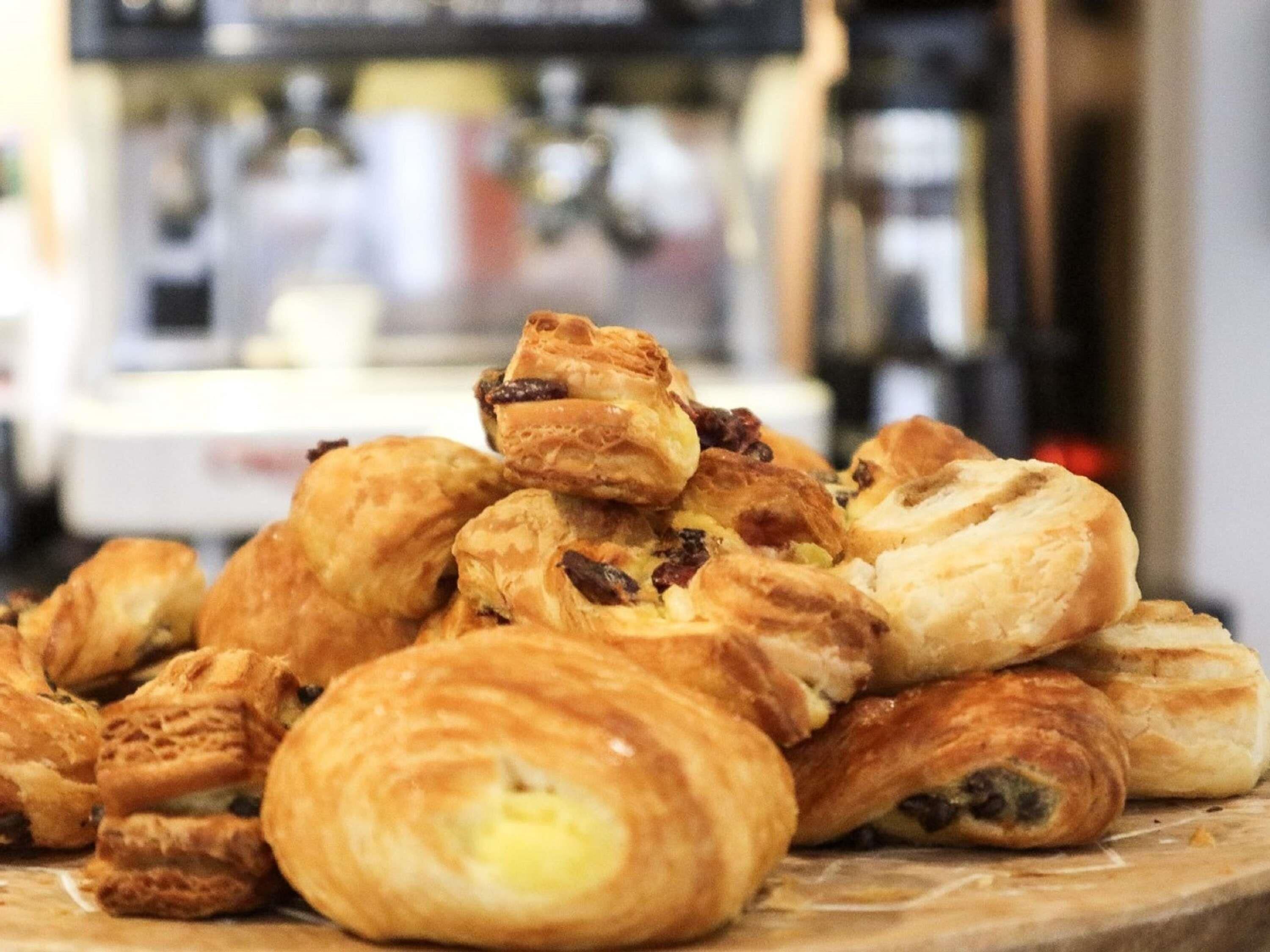 A variety of pastries on display, likely in a bakery or cafe setting.