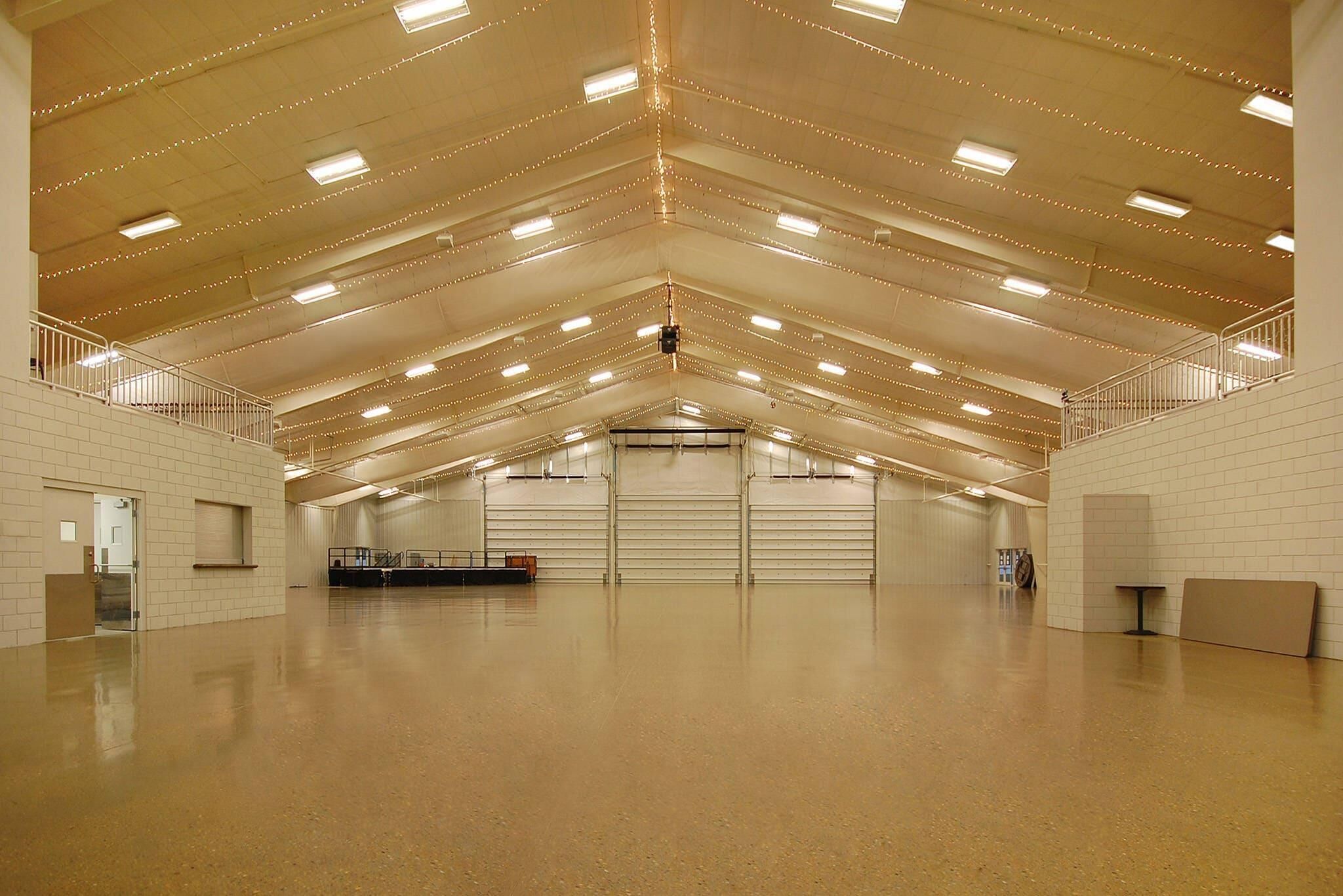 A spacious indoor area with high ceilings, multiple staircases, and a central open space.