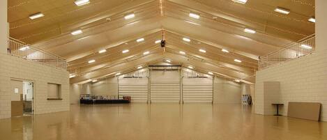 A spacious indoor area with high ceilings, multiple staircases, and a central open space.