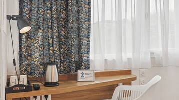 Desk, laptop workspace, iron/ironing board, free cots/infant beds