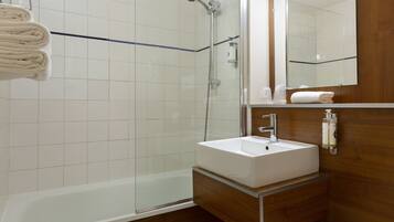 Bathtub, eco-friendly toiletries, hair dryer, towels