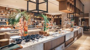 A buffet setup with various bowls, plates, and a central serving area. - Holiday Inn Resort Sanya Bay by IHG (Sanya)