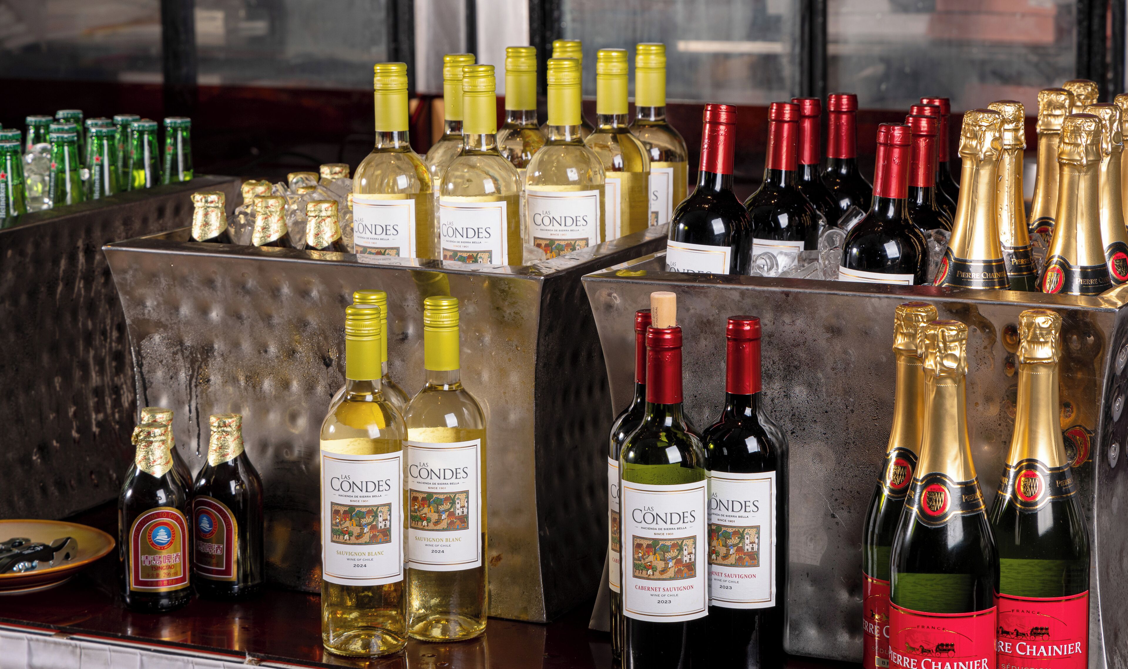 A variety of wine bottles displayed on a bar counter.
