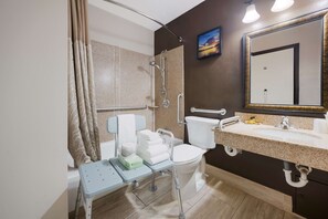 A modern bathroom with a shower, toilet, and sink. - Best Western Executive Inn (Battle Creek)