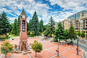 A clock tower, a plaza with benches, and a modern building. - Hilton Vancouver Washington (Vancouver)