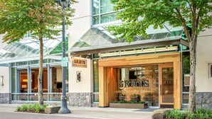 A hotel entrance with a modern design, large windows, and a sign that reads "GRAYS". - Hilton Vancouver Washington (Vancouver)