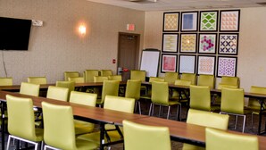 A conference room with multiple tables and chairs, a whiteboard, and framed patterns on the wall. - Holiday Inn Express & Suites Maryville by IHG (Maryville)