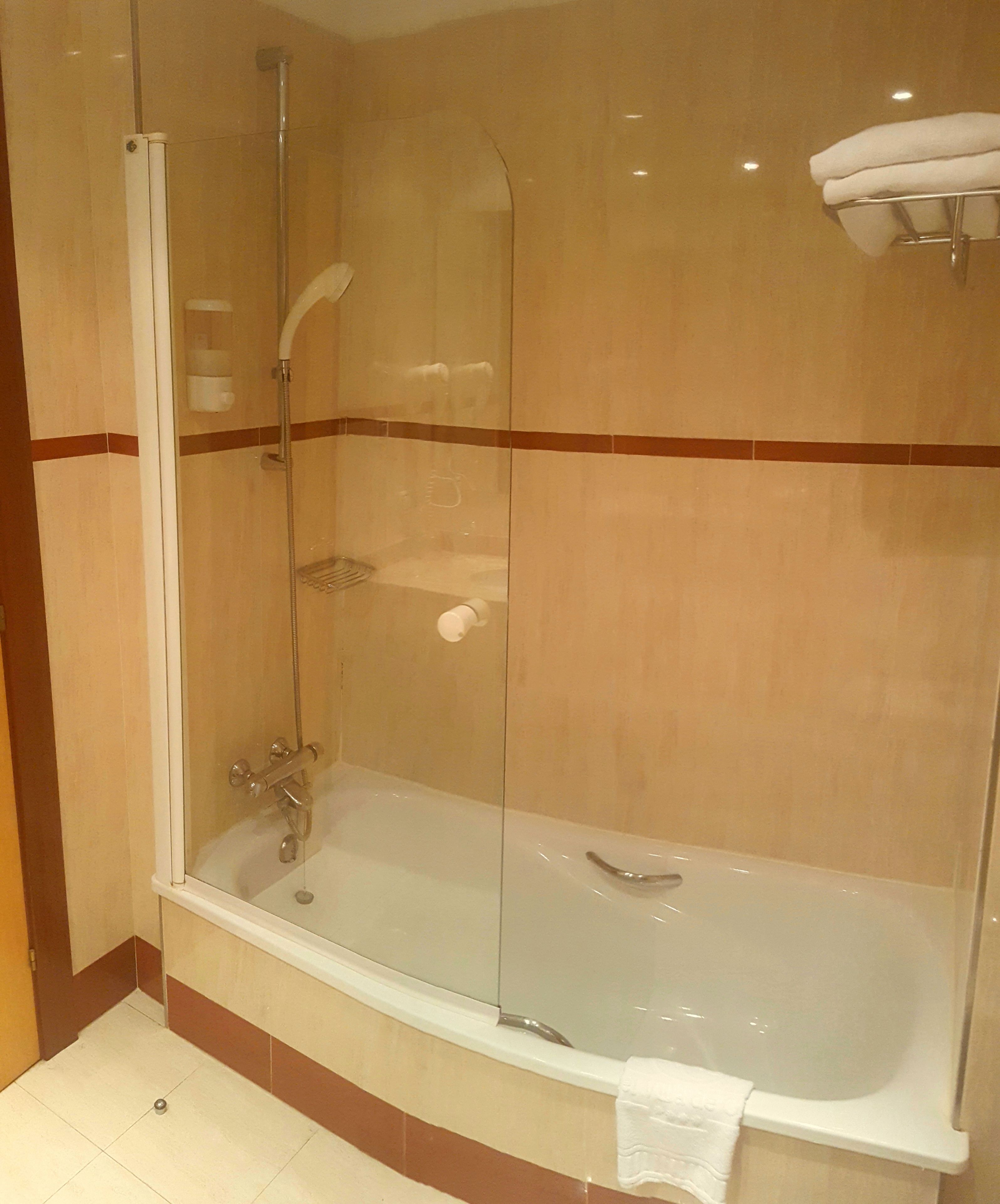 bathtub, free toiletries, hair dryer, towels