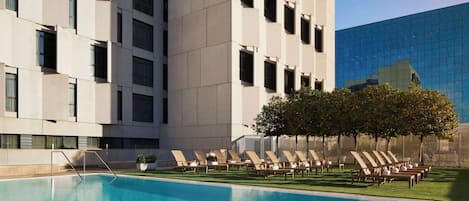 Seasonal outdoor pool, open noon to 9:00 PM, pool umbrellas