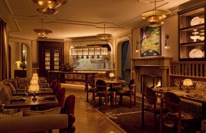 A luxurious hotel lobby with a bar, seating areas, and a fireplace. - The Chanler at Cliff Walk (Newport)