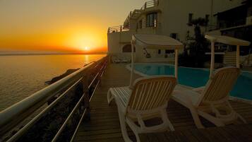 Outdoor pool, open 9:00 AM to 7:00 PM, pool umbrellas, sun loungers