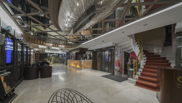 A spacious lobby with a central seating area, a staircase, and a reception desk. - Grand Star Hotel Bosphorus & Spa (Istanbul)
