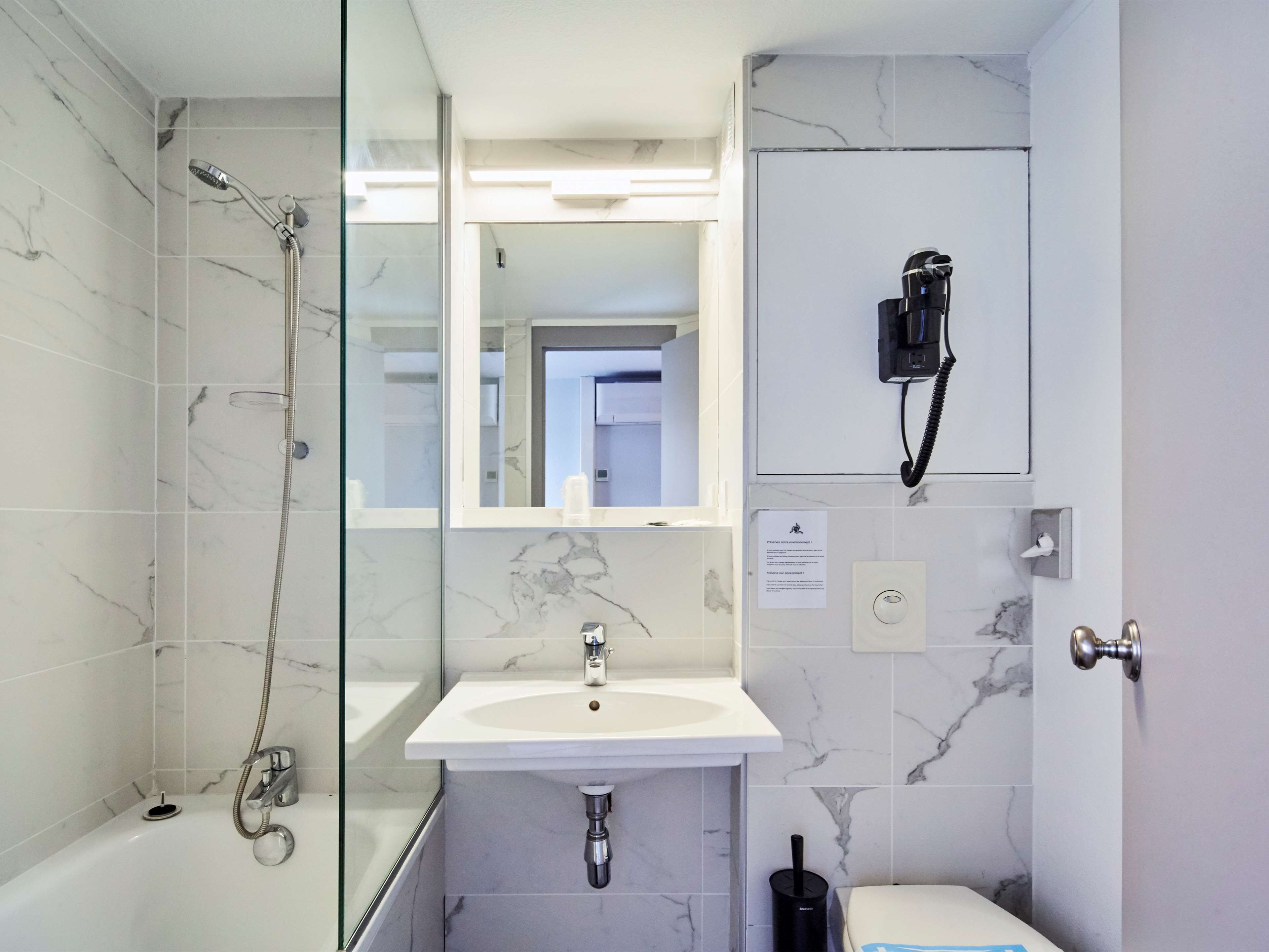 bathtub, eco-friendly toiletries, hair dryer, towels