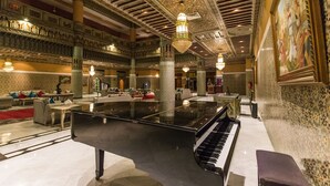 A grand lobby with a piano, ornate ceiling, and a large painting. - Royal Mirage Deluxe Marrakech (Marrakech)