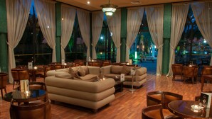 A spacious lounge area with a large sectional sofa, multiple tables, and chairs. - Royal Mirage Deluxe Marrakech (Marrakech)