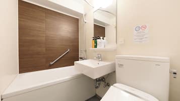A modern bathroom with a wooden vanity, a white sink, and a TOTO toilet.